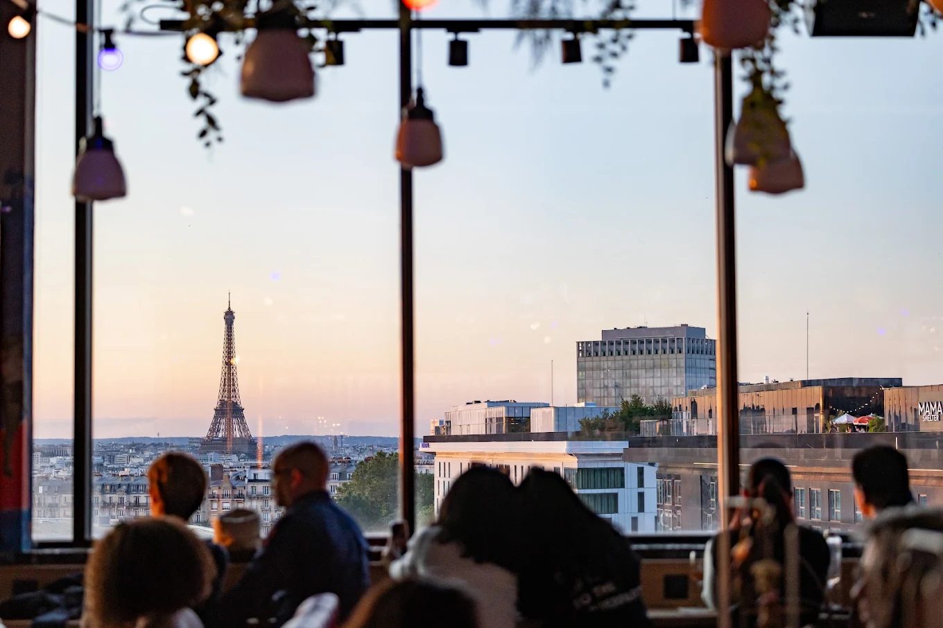 The Eiffel Tower seen from the Eklo rooftop at sunset