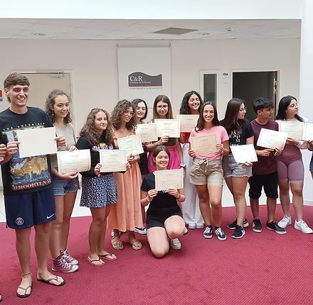 Students proudly holding their French certificates