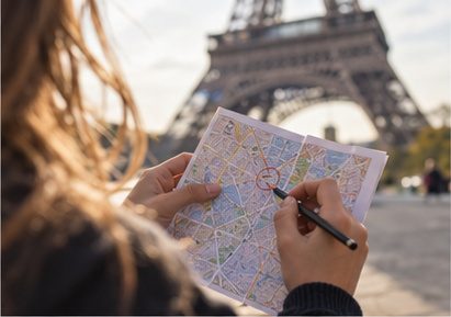 A student reading a map near the Eiffel Tower